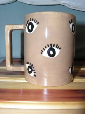 A picture of the back of the mug Emmy made me, which shows stylized eyes.