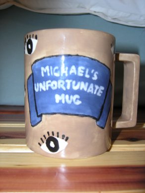 A picture of the front of the mug Emmy made me, which says "Michael's Unfortunate Mug."